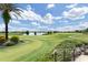 Scenic view of a manicured golf course with water features and lush greenery at 7634 Windy Hill Cv, Bradenton, FL 34202