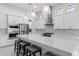 Spacious kitchen island with stainless steel appliances, white cabinets, and pendant lighting at 7634 Windy Hill Cv, Bradenton, FL 34202