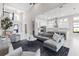 Bright, open living room and kitchen boasts high ceilings, modern finishes, and seamless flow for entertaining at 7634 Windy Hill Cv, Bradenton, FL 34202