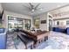 Covered outdoor dining area with a dining table and bar with outdoor kitchen in a luxury home at 7634 Windy Hill Cv, Bradenton, FL 34202