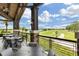 Outdoor seating on covered patio with stone pillars overlooking the golf course at 7634 Windy Hill Cv, Bradenton, FL 34202