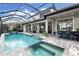 Relaxing outdoor space with a pool, spa, and entertainment area perfect for enjoying sunny days at 7634 Windy Hill Cv, Bradenton, FL 34202
