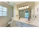 Bathroom featuring double sinks, granite countertops, modern lighting, and stylish fixtures at 803 Montrose Dr # 201, Venice, FL 34293