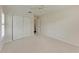 This is a bright bedroom with a window, closet, neutral carpet, and a ceiling fan at 803 Montrose Dr # 201, Venice, FL 34293