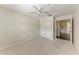 Spacious carpeted bedroom featuring a ceiling fan and double closet with doors at 803 Montrose Dr # 201, Venice, FL 34293