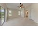 Bright bedroom with carpet flooring, ceiling fan and access to a private balcony at 803 Montrose Dr # 201, Venice, FL 34293