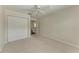Carpeted bedroom offers ceiling fan, double closet, and ensuite bathroom access at 803 Montrose Dr # 201, Venice, FL 34293