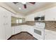 Clean kitchen with white cabinets, modern appliances, and stylish backsplash at 803 Montrose Dr # 201, Venice, FL 34293