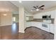 Modern white kitchen with stainless steel appliances and decorative backsplash, hardwood flooring at 803 Montrose Dr # 201, Venice, FL 34293