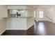 Open kitchen and dining area with granite countertops and hardwood flooring at 803 Montrose Dr # 201, Venice, FL 34293