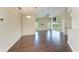 Open-concept living area with a ceiling fan, hardwood floors, and sliding glass doors to the outside at 803 Montrose Dr # 201, Venice, FL 34293