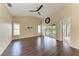 Bright, open living room features wood floors, sliding doors to the lanai, and high ceilings at 803 Montrose Dr # 201, Venice, FL 34293