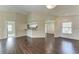 Living room showcasing hardwood floors, leading to the kitchen and dining area at 803 Montrose Dr # 201, Venice, FL 34293