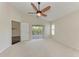 The main bedroom features a ceiling fan, neutral carpet, and a sliding door to the outdoor area at 803 Montrose Dr # 201, Venice, FL 34293