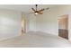 Spacious main bedroom features neutral carpeting, ceiling fan, and ensuite bathroom and walk-in closet at 803 Montrose Dr # 201, Venice, FL 34293