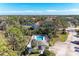 A beautiful community pool sits atop a small building surrounded by a deck with lounge chairs and lush landscaping at 803 Montrose Dr # 201, Venice, FL 34293
