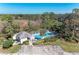 Aerial view of a pristine pool surrounded by lush landscaping and a cabana at 803 Montrose Dr # 201, Venice, FL 34293