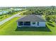 Aerial view of backyard featuring a screened-in patio and overlooking a lush green lawn at 8045 Bosco Rd, Port Charlotte, FL 33981