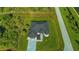An aerial view of the home reveals its well-manicured lawn, stone driveway, and modern architecture at 8045 Bosco Rd, Port Charlotte, FL 33981