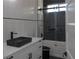 Modern bathroom features a sleek black sink, contrasting shower, and stylish fixtures at 8045 Bosco Rd, Port Charlotte, FL 33981