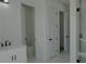 Bright bathroom showcasing white cabinets, marble walls and glass enclosed shower at 8045 Bosco Rd, Port Charlotte, FL 33981