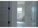 Bright bathroom with a freestanding tub next to a window and a vanity with marble surround at 8045 Bosco Rd, Port Charlotte, FL 33981