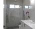 This bathroom is complete with modern shower, gray tile, and vanity at 8045 Bosco Rd, Port Charlotte, FL 33981
