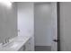 Bright bathroom featuring a modern vanity and light gray wall tiles at 8045 Bosco Rd, Port Charlotte, FL 33981