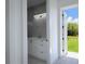 Bright bathroom area with modern vanity that opens to an outdoor view, creating a refreshing space at 8045 Bosco Rd, Port Charlotte, FL 33981