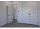 Bedroom with wood-look floors, a walk-in closet with bi-fold doors, and an interior door at 8045 Bosco Rd, Port Charlotte, FL 33981