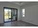 Bedroom featuring sliding glass doors and large windows at 8045 Bosco Rd, Port Charlotte, FL 33981