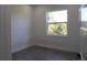 This bedroom offers plenty of natural light with a window and wood flooring at 8045 Bosco Rd, Port Charlotte, FL 33981