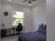 This bedroom offers plenty of natural light and is furnished with a bed, desk, and chair at 8045 Bosco Rd, Port Charlotte, FL 33981