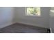 Bright bedroom with wood-look flooring, white walls, and a natural view through the window at 8045 Bosco Rd, Port Charlotte, FL 33981