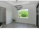 Bright dining room featuring a modern light fixture, and a large window providing natural light and beautiful view at 8045 Bosco Rd, Port Charlotte, FL 33981