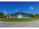 Contemporary home showcasing a well-maintained lawn and architectural design on a sunny day at 8045 Bosco Rd, Port Charlotte, FL 33981