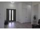 Bright foyer featuring modern double doors, light wood floors, and white walls at 8045 Bosco Rd, Port Charlotte, FL 33981