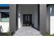 Modern home entrance with a double front door, gray accents and stone walkway at 8045 Bosco Rd, Port Charlotte, FL 33981
