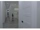 Hallway view featuring modern doors and light gray wood flooring at 8045 Bosco Rd, Port Charlotte, FL 33981