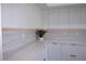 Stylish kitchen with white cabinetry, countertops, backsplash lighting and marble-look backsplash at 8045 Bosco Rd, Port Charlotte, FL 33981