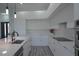 Contemporary kitchen with sleek white cabinetry, stainless steel appliances, and a large island with sink at 8045 Bosco Rd, Port Charlotte, FL 33981
