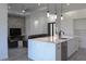 Modern kitchen with white cabinets, quartz countertops, stainless steel appliances, and barstool seating at 8045 Bosco Rd, Port Charlotte, FL 33981