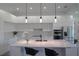 Modern kitchen featuring white cabinets, a spacious island with seating, and stainless steel appliances at 8045 Bosco Rd, Port Charlotte, FL 33981
