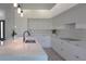 Beautiful kitchen featuring white cabinetry, modern appliances, and a large central island with a sink at 8045 Bosco Rd, Port Charlotte, FL 33981