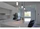 Bright kitchen showcasing an island with quartz countertops, modern lighting, and stainless steel appliances at 8045 Bosco Rd, Port Charlotte, FL 33981