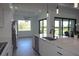 Modern kitchen with sleek appliances, a large central island, and a view of the outdoor space at 8045 Bosco Rd, Port Charlotte, FL 33981