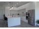 Sleek, modern kitchen with stainless steel appliances, white cabinetry, and quartz countertops at 8045 Bosco Rd, Port Charlotte, FL 33981