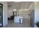 Modern kitchen with stainless steel appliances, island, and white cabinets at 8045 Bosco Rd, Port Charlotte, FL 33981