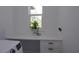 This laundry room features a built-in desk, cabinet space, and a window for natural light at 8045 Bosco Rd, Port Charlotte, FL 33981
