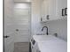Bright laundry room with modern machines, a black faucet, and plenty of storage space at 8045 Bosco Rd, Port Charlotte, FL 33981